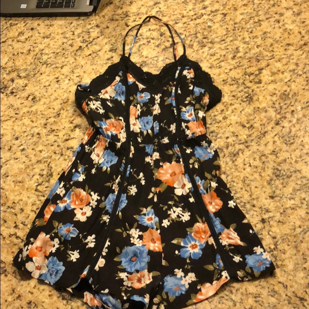 Black floral spaghetti strap cross back romper